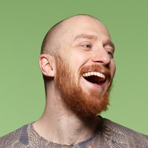 Headshot of Tam Finlay, smiling against a green background.